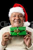 Smiling Old Man Handing Over A Wrapped Green Gift