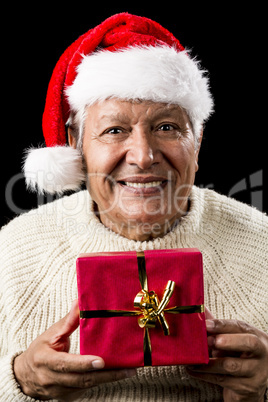 Aged Man With Santa Claus Cap and Red Xmas Gift