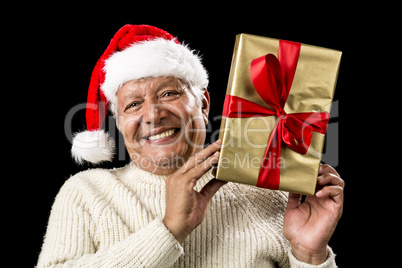 Smiling Old Man With Golden Gift Isolated On Black