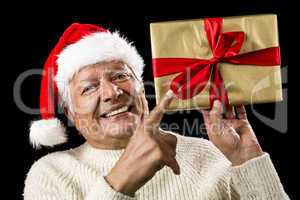 Avid Aged Man Pointing At Golden Wrapped Present