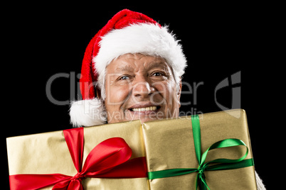 Smiling Aged Man Peeking Across Two Golden Gifts