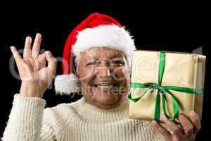 Grinning Male Senior With Gift Gesturing OK Sign