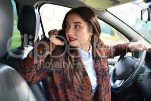 woman driving a car talking on the phone