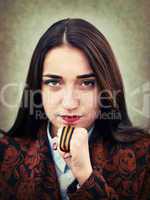 Portrait of young girl with St. George's ribbon in hand