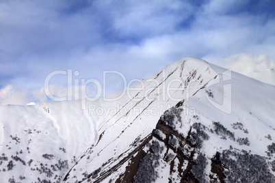 Off-piste slope in morning and sky with clouds