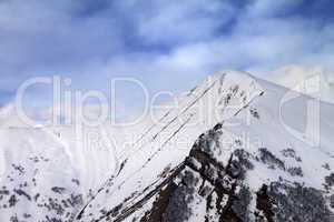 Off-piste slope in morning and sky with clouds