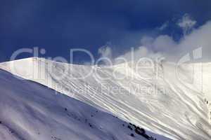 Off-piste slope in sun evening