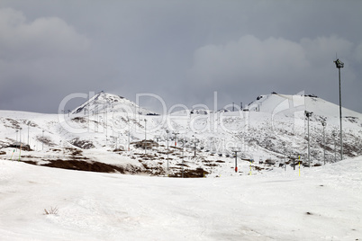 Ski slopes at gray day, in little snow year