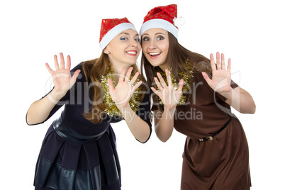 Image of two happy young woman in christmas hats