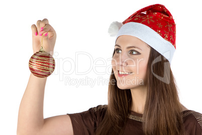 Photo of young woman looking at christmas ball