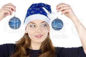 Image of young woman looking at christmas balls