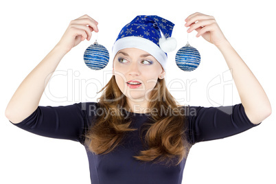 Portrait of young woman looking at christmas balls