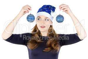 Portrait of young woman looking at christmas balls