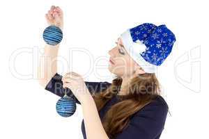 Photo of woman decorating wall with balls
