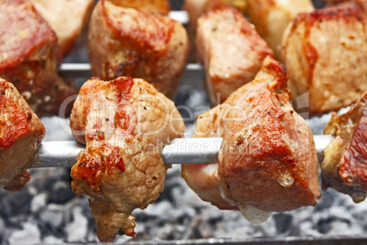 Shish kebab on metal skewers close-up