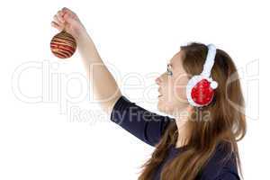 Woman in winter headphones decorating wall