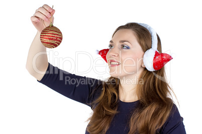 Woman in winter headphones decorating wall