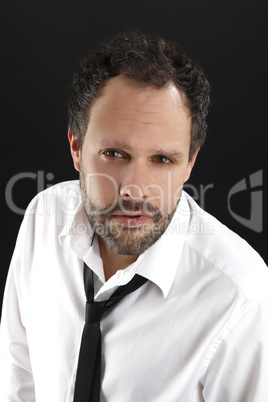 Attractive man with white shirt and black tie looks into the cam