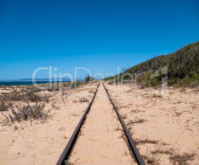Steel Railroad Tracks on Sand Beach