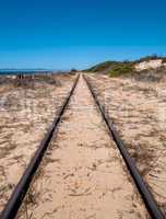 Steel Railroad Tracks on Sand Beach