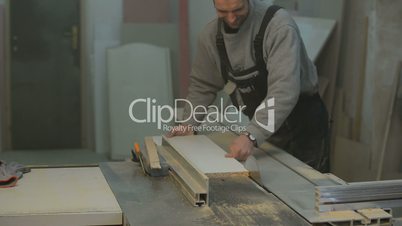 carpenter cutting the wooden panel