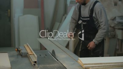 carpenter cutting the wooden panel