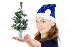 Woman with small christmas spruce