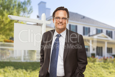 Male Real Estate Agent in Front of Blank Sign and House