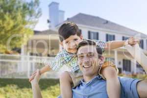 Mixed Race Father and Son Piggyback in Front of House