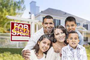 Hispanic Family in Front of Sold Real Estate Sign, House