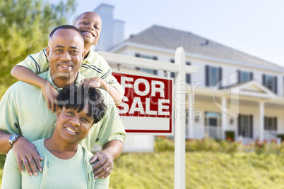 African American Family In Front of Sale Sign and House