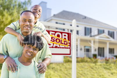 African American Family In Front of Sold Sign and House