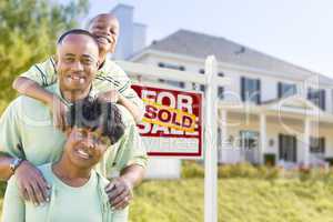 African American Family In Front of Sold Sign and House