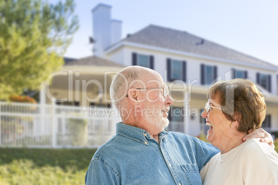 Happy Senior Couple in Front Yard of House