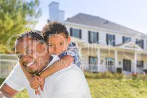 African American Father and Mixed Race Son, House Behind