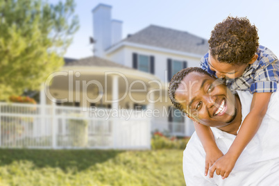 African American Father and Mixed Race Son, House Behind