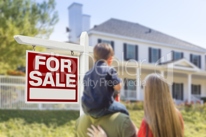 Family Facing For Sale Real Estate Sign and House