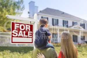 Family Facing For Sale Real Estate Sign and House