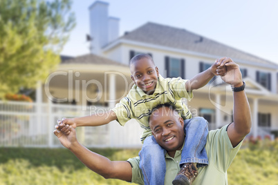Playful African American Father and Son In Front of Home