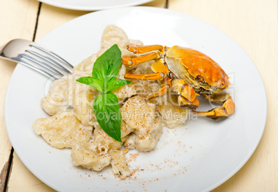 Italian gnocchi with seafood sauce with crab and basil