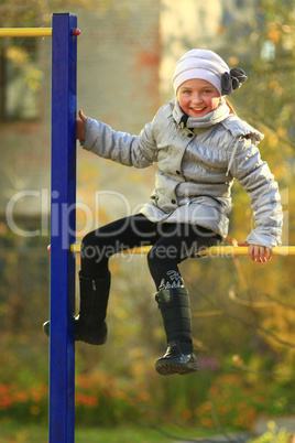 blue-eyed girl on the horizontal bar