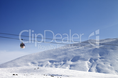 Gondola lift and ski slope at nice sun day