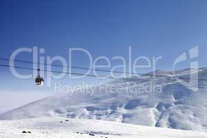 Gondola lift and ski slope at nice sun day