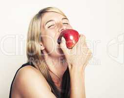 Woman biting on apple