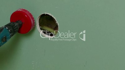 Repairer Make Drilling a Round Hole in a Drywall, closeup