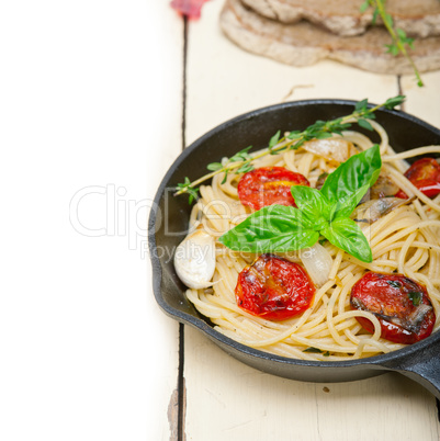 spaghetti pasta with baked cherry tomatoes and basil