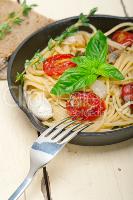 spaghetti pasta with baked cherry tomatoes and basil