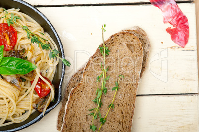 spaghetti pasta with baked cherry tomatoes and basil