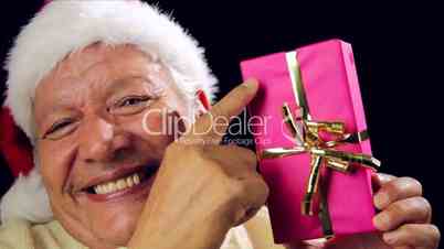 Cheerful Old Man Showing A Pink Wrapped Xmas Gift
