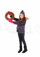 Girl holding a wreath up.